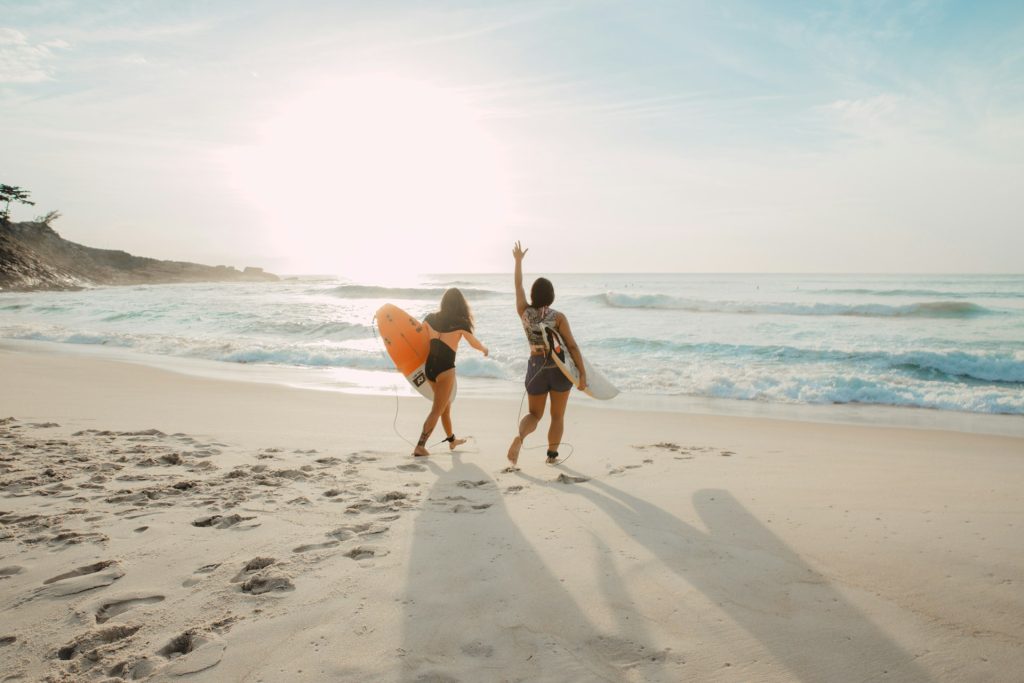 A group of people on the beach having fun